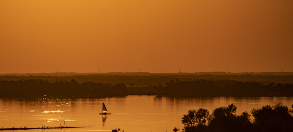  A sailboat glides through Granger Lake water  near the Granger Lake Dam near sunset  on Tuesday, October 15, 2024. 