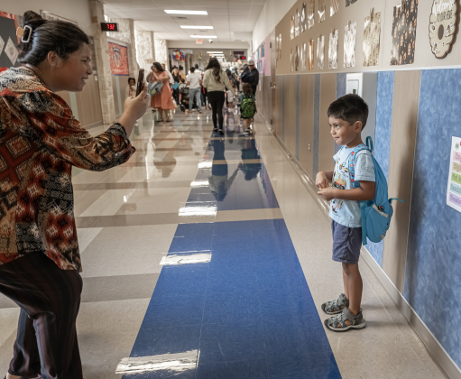 Shraddha Mismra takes a photo of her son Migel, 4, before he goes into his Pre-K classroom   on Wednesday, August 19, 2026,  the first day of classes at George Washington Carver Elementary School.