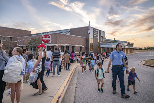 Families  line up for entry to the school on Wednesday, August 19, 2026,  the first day of classes at George Washington Carver Elementary School.
