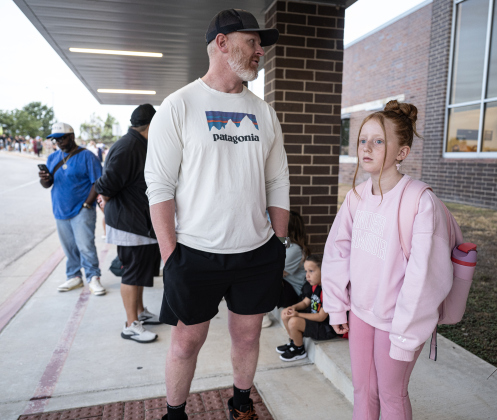 Fifth-grader Grace Homan waits for school entry with her dad John Homan  on Wednesday, August 19, 2026,  the first day of classes at George Washington Carver Elementary School.