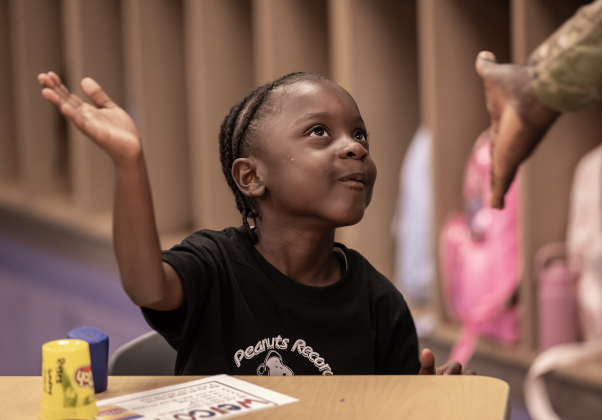 Kindergartener Ronald Pierre, Jr.  who turns 5 on Sunday, gives a high-five to his father,  Army Second Lt. Ronald Pierre on Wednesday, August 19, 2026,  the first day of classes at George Washington Carver Elementary School.