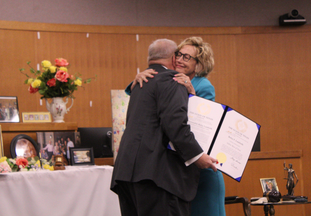 Greg Davidson from Governor Greg Abbott’s Office, left, hugs Judge Lambeth after reading a recognition from the Governor's Office. Judge Lambeth was the family attorney when Mr. Davidson adopted his daughter 25 years ago. Photo by Nalani Nuylan.