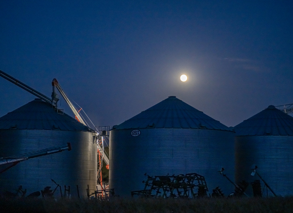Grain elevators are seen under a Full Moon as they await harvested corn along County Road 369 on Tuesday, July 28, 2026.    Photo by Andy Sharp