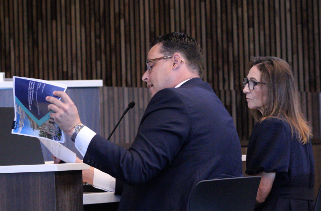 Ryan Murray with ETC Institute, left, reads findings from a recent resident survey to the Williamson County Commissioners Court, August 25. Williamson County Director of Communications Connie Odom, right, joins him. Photo by Nalani Nuylan.
