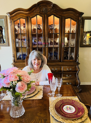 Georgetown resident Virginia Cambron sits at her table with part of her large collection of glassware and fine china. 
