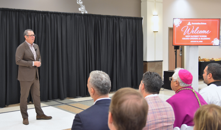 Ascension President and CEO Eduardo Conrado, left, speaks to attendees about the new six-story tower at Ascension Seton in Round Rock. The ribbon cutting for the new tower was held on August 21. (Photo by Kaitlyn Wilkes)