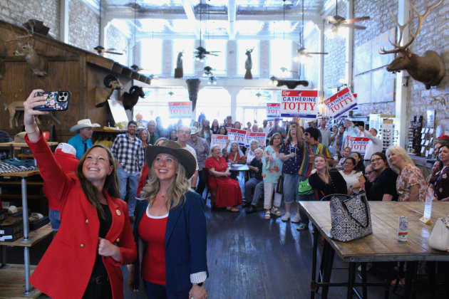Catherine Totty, front left, poses with State Representative Caroline Harris Davila, far left, as she takes a photo with Ms. Totty’s supporters at her campaign kick-off.  Photo by Nalani Nuylan.