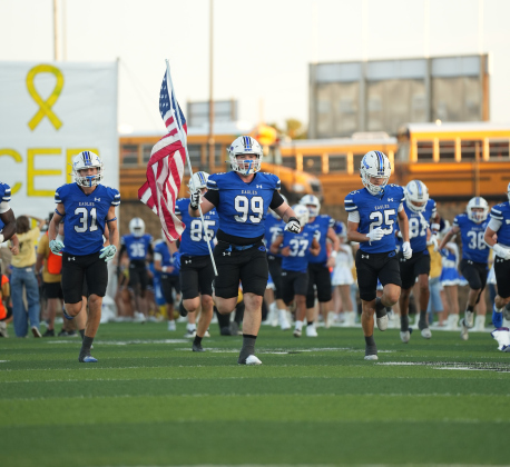 No. 99 Ethan Casey leads the Eagles onto the field Friday, September 4.   Photos by Lawson Richter