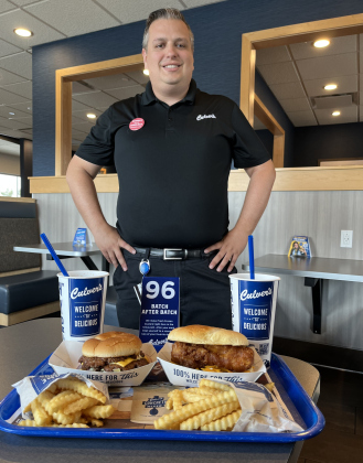 Andrew Gravely, who owns the Georgetown Culver’s, serves a Butter Burger and fish sandwich meal. Culver’s honors senior citizens every second Tuesday of the month and has a monthly senior raffle.   Photo by Linda Dwyer