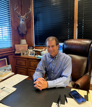 Nyle Maxwell sits in his office at Nyle Maxwell Chrysler Dodge Jeep RAM of Austin. He’s this year’s honoree at the Williamson Museum Cattleman’s Ball.  Photo by Abbey Archer