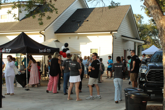 A crowd of volunteers and community members for the Isaiah 117 House gather and mingle during the birthday festivities. Photo by Nalani Nuylan.