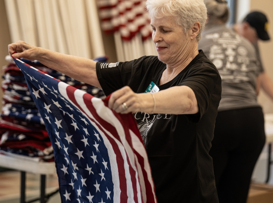 Volunteer Holly Reads inspects the Rotary Club’s American flags during the 2025 National Day of Service at Christ Lutheran Church September 13, 2025. 