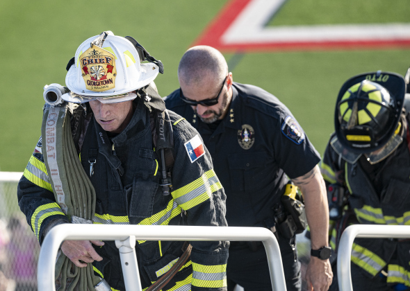 Georgetown Fire Department Chief John Sullivan, front, and Georgetown Police Department Chief Cory Tchida participate in the 2025 stair climb at the Georgetown High School football field. (Georgetown Fire Department)