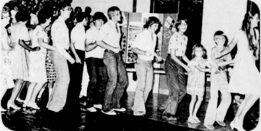 September 12, 1976: GETTING IN ON THE ACTION - Georgetown folks get in on the action at the Up with People concert Tuesday night as they bunny hop around Southwestern University's new Sid W. Richardson Physical Education Center. The program, designed to establish a creative framework for communication and interaction between people of varied backgrounds and across all ages, seems to be working as Georgetownites bunnyhop, swaying arm-in-arm to the music, singing and clapping.