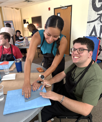 Cole Smith crafting with Mia Reyna who is a part of the professional support staff. Photo by Abbey Archer