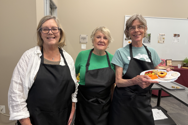 Debra Nix, Susi Hinton and Ellen Kennedy hold food they made during the Cooking Across Cultures workshop, including a olive hummus appetizer and grilled peach dessert. Photo by Abbey Archer