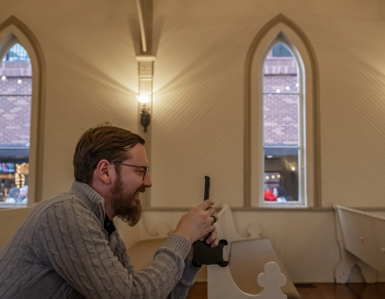Jordan Reichenberger takes photographs inside the Grace Heritage Center during Georgetown’s Art Stroll on Friday, October 16, 2026. Jordan and his wife Brittaney were married here in 2022. Photo by Andy Sharp
