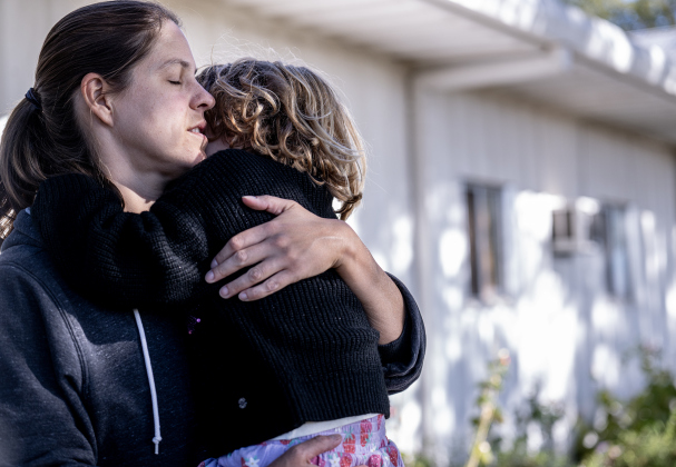 Amy Masheter, wife of Pastor Philip Daniels, takes time out from a busy afternoon to hug their daughter Hannah, 5, during the Third Annual St. Peter Lutheran Church Hamburger Fundraiser on Saturday, October 17, 2026. A Country Store and Quilt Raffle were also held. The church is at 2929 FM 972 in Walburg. Photo by Andy Sharp.