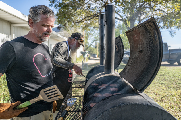 Pastor Philip Daniels, left, and Dave Reed keep a close eye on hamburgers being grilled during the Third Annual St. Peter Lutheran Church Hamburger Fundraiser on Saturday, October 17, 2026. A Country Store and Quilt Raffle were also held. The church is at 2929 FM 972 in Walburg. Photo by Andy Sharp