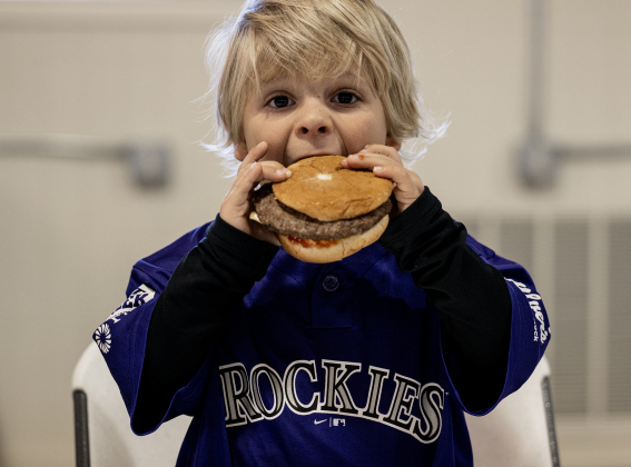 Isaac Makal, 3, enjoys his hamburger during the Third Annual St. Peter Lutheran Church Hamburger Fundraiser on Saturday, October 17, 2026. A Country Store and Quilt Raffle were also held. The church is at 2929 FM 972 in Walburg. Photo by Andy Sharp