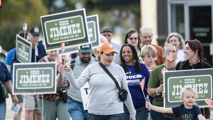 Erin Block, candidate for Williamson County Clerk, center (in UT ball cap) is joined by others, including Leslie Booker (in purple shirt), candidate for Judge of the 512th, and Chris Jimenez, running for Texas House District 52 (not pictured) as the group marches along 4th Street toward Taylor City Hall on Monday, October 19, 2026. The event was coordinated by the East Wilco Democrats. Jimenez and his wife Katy cast their ballots. Photo by Andy Sharp