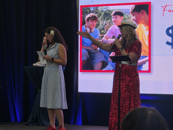 Marissa Austin, left, wipes her tears as audience members donate to Court Appointed Special Advocates of Williamson County during its Wine, Women and Shoes fundraiser, September 26. Photo by Nalani Nuylan.