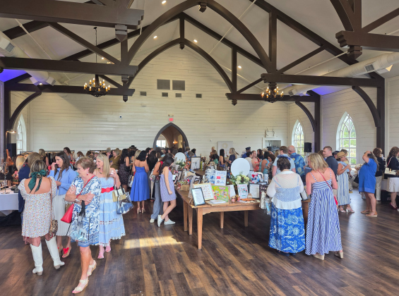 Participants at the Wine, Women and Shoes shop around different vendors and silent auction items in the Chapel room at High Pointe Estate in Liberty Hill. Photo by Nalani Nuylan.