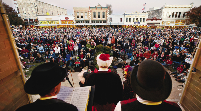 On the steps of the historic Williamson County Courthouse, the Austin Carolers entertain the crowd gathered at the Georgetown Square for the Lighting of the Square November 28, 2014. A large crowd filled the streets of downtown Georgetown for this annual holiday tradition. SUN ARCHIVE