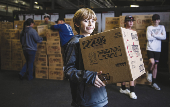 Carson Marks, 11, helps distribute gift boxes to families during the Georgetown Police Department’s annual Blue Santa gift distribution December 18, 2021, at the city’s Public Safety headquarters on D.B. Wood Road. SUN ARCHIVE
