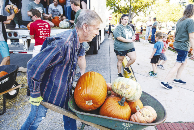 Jim Wilson was one of the volunteers helping unload 2,650 pumpkins.