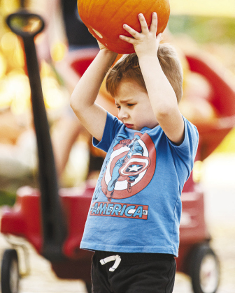 Lincoln Sanchez, 4, carries his chosen pumpkin.