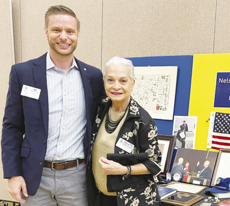 Jeanette Herrington and President Elect Jeff Cartledge pose beside Rotary member Nelson Barrett’s memorial table. KATE THURMOND