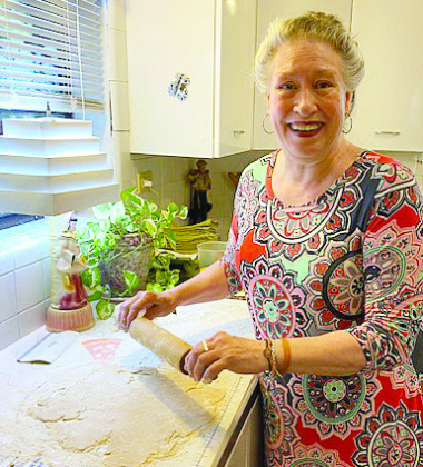 PJ Moore rolls out a fresh pie crust.