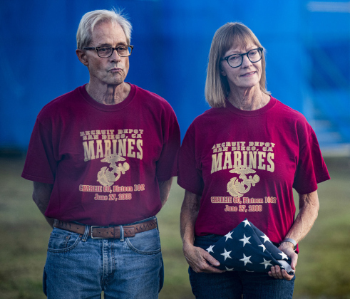 Ann Kaiser and her husband Glen Kaiser take part in the flag retirement ceremony for a flag belonging to her son, U.S. Marine Corps member Matthew Johnson.