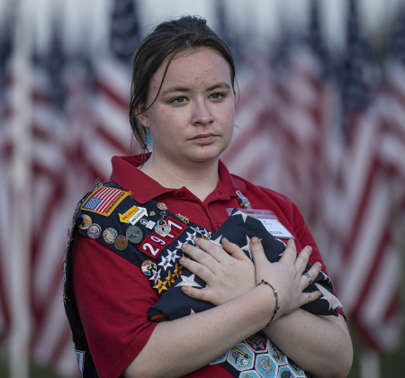 Maria Combs cradles a flag brought for retirement.