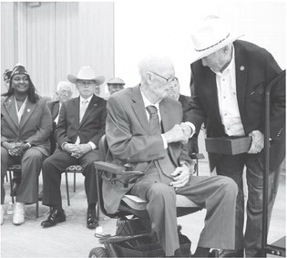 Staff Sergeant Carl Doering, who served as Georgetown’s mayor from 19841986, receives an award October 15 from U.S. Representative John Carter. • Aviation Boatswain George P. Willey Texas A&amp;amp;M and the Central Texas Color Guard retired the colors, and Mr. Carter closed the ceremony with a short address.