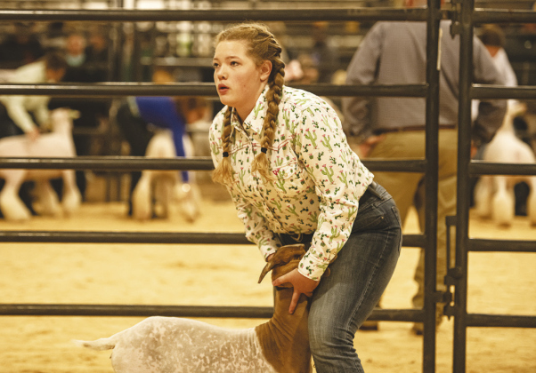 Cassidy Wilson, 13, of Georgetown calms her goat, Darlin’.