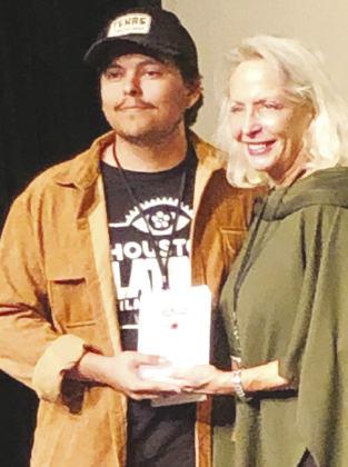 GTX Film Festival Executive Director Beth Baker awards Alexander Rosales for Best Student Short.