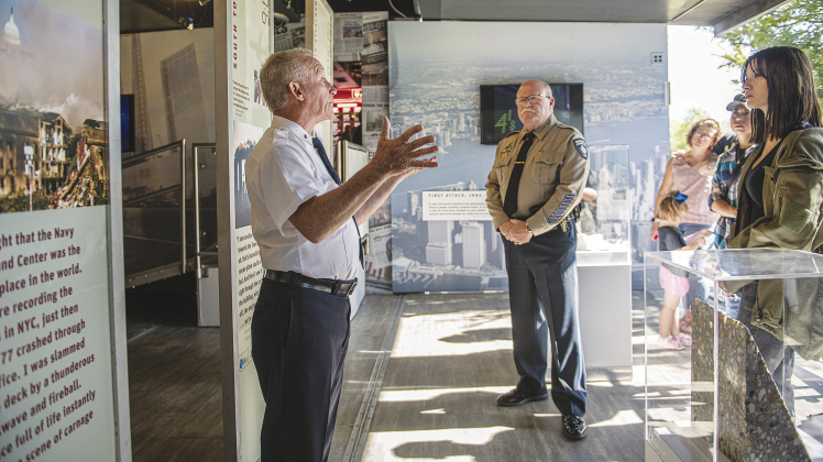 Steven Casquarilli, left, a retired New York City Fire Department firefighter, speaks to a group at the “Tunnel to Towers 9/11 Never Forget” exhibit at the Field of Honor Sunday, November 6. Included in the group was Williamson County Sheriff Mike Gleason, center.