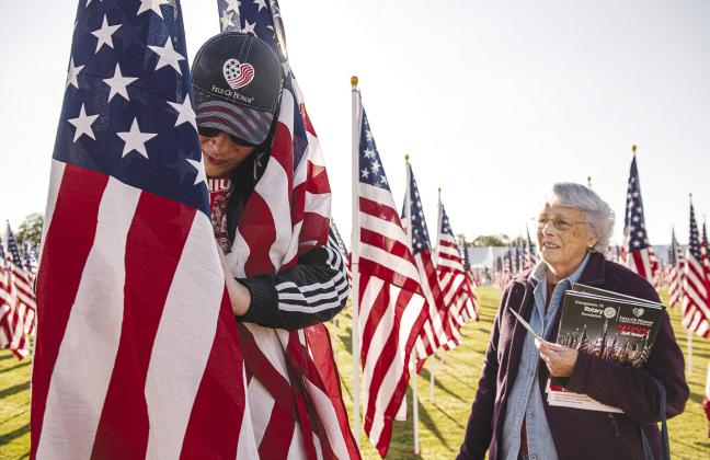 Volunteer William Armbruster helps place flags for Ruth Jackson.The Field of Honor, sponsored by the Rotary Club of Georgetown, will be on display at San Gabriel Park throughout the week.