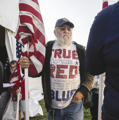 Luis Zavala, Jr., 74, brought in two flags — one for him, one for his father — to be reposted.