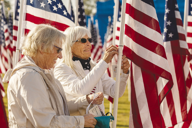 Patricia Levy, left, and Susie Marr, both Blue Star Mothers, check flag name tags.