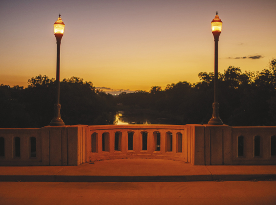Left and below, The lights glow on the bridge spanning the San Gabriel River near San Gabriel Park.