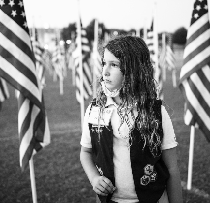 Kayla Pettengill, a member of Georgetown’s American Heritage Girls Troop 1045, pauses while placing name tags on flags at the Georgetown Rotary Club’s annual Field of Honor on its opening day at San Gabriel Park November 7, 2020. SUN ARCHIVE
