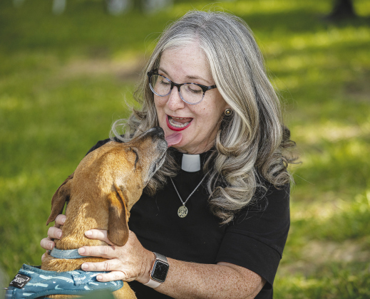 Reverend Sharolyn Browning, pastor at Christ Lutheran Church, gets a kiss from Scooby, owned by 13-year-old Evan Haley and his family, during the church’s Blessing of the Animals, held Sunday afternoon. Grace Episcopal Church will be holding its Blessing of the Animals service at San Gabriel Park this weekend, 11 a.m., October 9.
