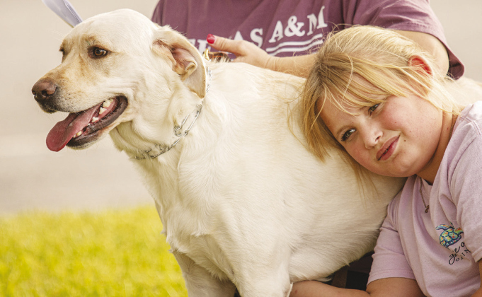 Sydnee Sands, 11, waits for her dog Diesel to be blessed by Reverend Sharolyn Browning.