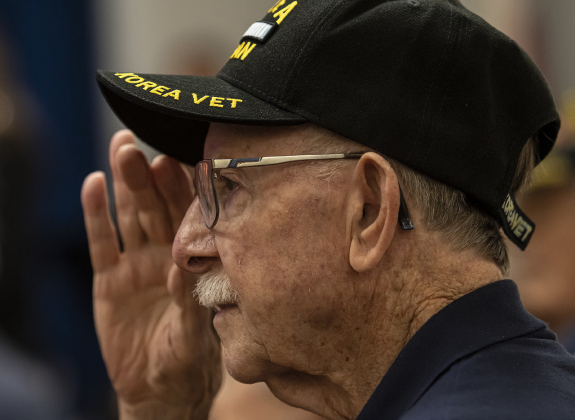 Korean War veteran Will Holton, 92, who served in the Navy, salutes during the playing of “The National Anthem.”