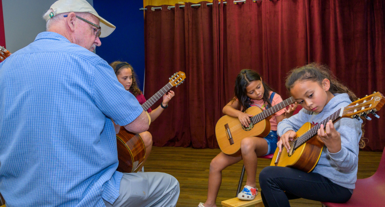 Kevin Taylor teaches Aylah, 11, Liyah, 10, and Ahni Vasquez, 9. GARY HOOK
