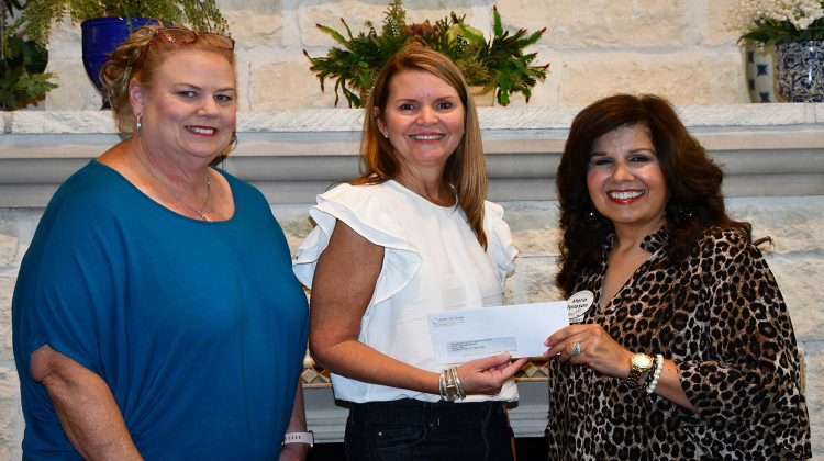 Board member Jami Nelson, Chairperson Kim Gibbons and Women Helping Others Vice President Maria Tolleson.