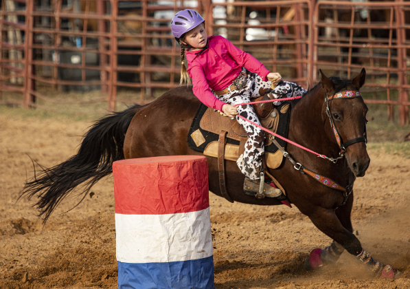 Lexi Miller, 8, participates in Young Guns &amp;amp; Alumni Barrel Racing during the 29th Annual Clayman Rodeo, held at Windsong Farm on Saturday.